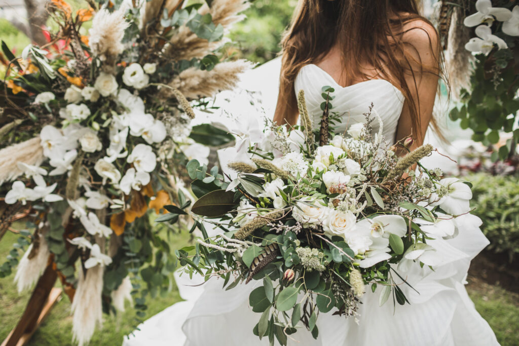 woman-holding-in-hands-big-wedding-bouquet-in-Brewster, Cape Cod