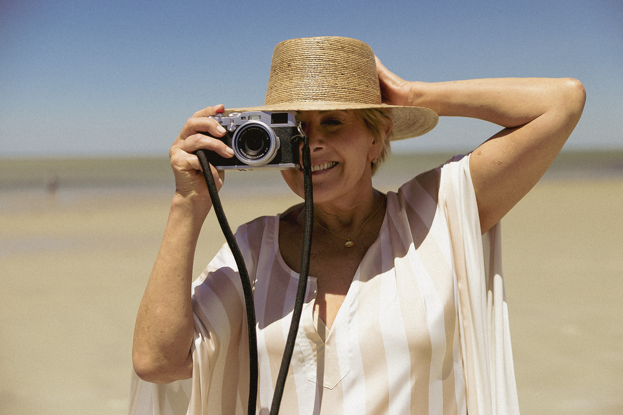 woman taking a photo on a beach